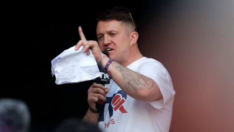 British far-right activist Tommy Robinson speaks during a rally in Parliament Square after the final leg of the "March to Leave" in London, Friday, March 29, 2019. Pro-Brexit demonstrators were gathering in central London on the day that Britain was originally scheduled to leave the European Union.