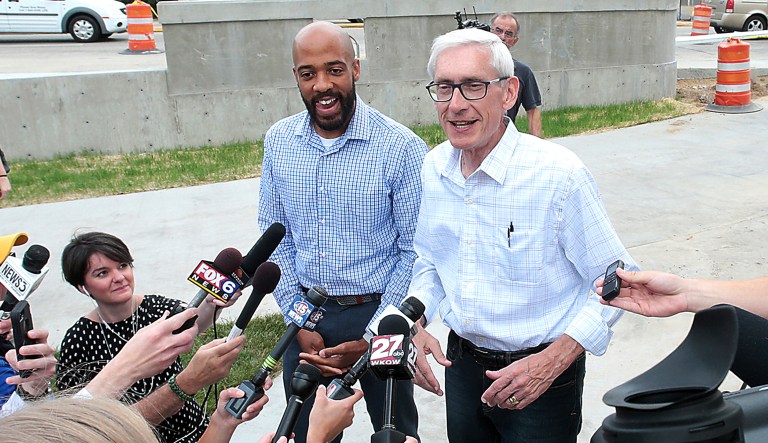 FILE - In this Aug. 15, 2018, file photo, Tony Evers, right, the Democratic candidate for Wisconsin governor and lieutenant governor Mandela Barnes speak with the media in Madison a day after winning their Democratic primaries. Evers and Republican Lt. Gov. Rebecca Kleefisch, both cancer survivors, are clashing over health care. Kleefisch has a new television ad out Friday, Sept. 14, 2018, that says as long as she and Gov. Scott Walker are in office, people with pre-existing conditions will be guaranteed health insurance. But Evers says Walker has no credibility on the issue because he's been an ardent opponent of the Affordable Care Act, which guarantees coverage for people with pre-existing conditions.