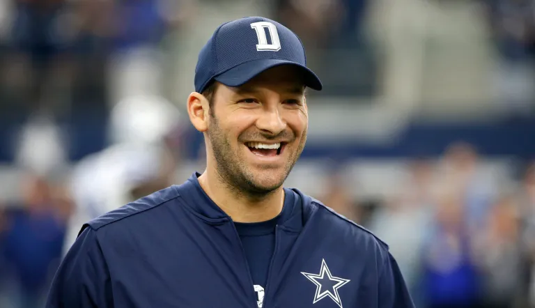 Dallas Cowboys quarterback Tony Romo smiles as he talks with teammates on the field during warm ups before an NFL football game against the Cincinnati Bengals on Sunday, Oct. 9, 2016, in Arlington, Texas.