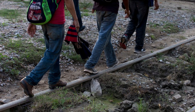 A small group of Honduran migrants trying to reach the U.S. border walk along train tracks in Trancas Viejas, Veracruz state, Wednesday, Oct. 24, 2018.