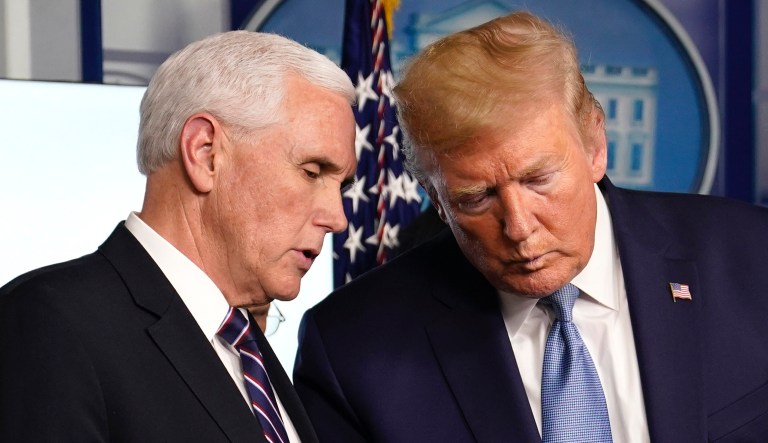 President Donald Trump listens to Vice President Mike Pence during a press briefing with the coronavirus task force, in the Brady press briefing room at the White House, Monday, March 16, 2020, in Washington.