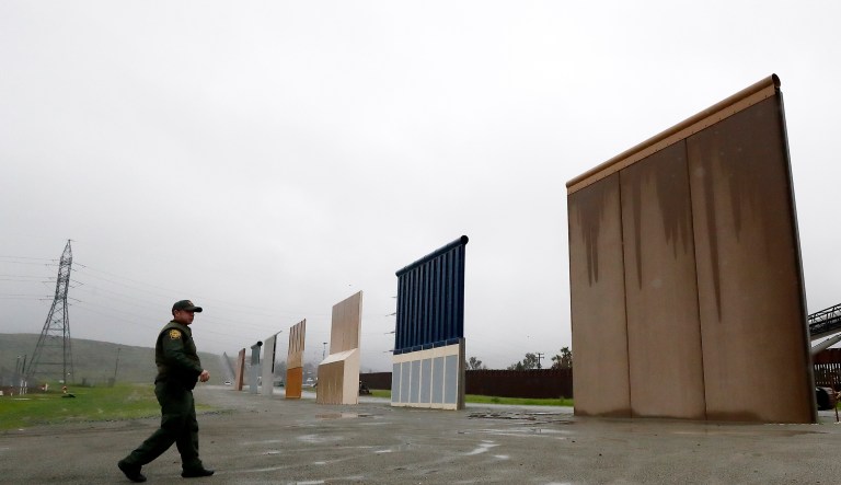 Border Patrol agent Vincent Pirro walks towards prototypes for a border wall Tuesday, Feb. 5, 2019, in San Diego. President Donald Trump is expected to speak about funding for a wall along the U.S.-Mexico border during his State of the Union address Tuesday.