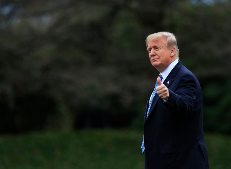 President Donald Trump flashes a thumbs up as he leaves the White House, Friday, Feb. 16, 2018, in Washington.