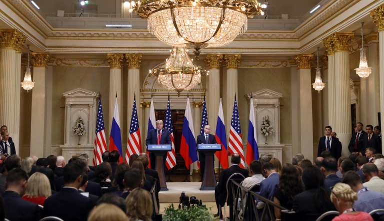 U.S. President Donald Trump, left, listens as Vladimir Putin, Russia's President, speaks during a news conference in Helsinki, Finland, on Monday, July 16, 2018. Trump said a two-hour, one-on-one meeting with Putin was a âgood startâ on Monday for their Helsinki summit, but gave no indication he had relented to increased pressure to confront the Kremlin leader over election meddling.
