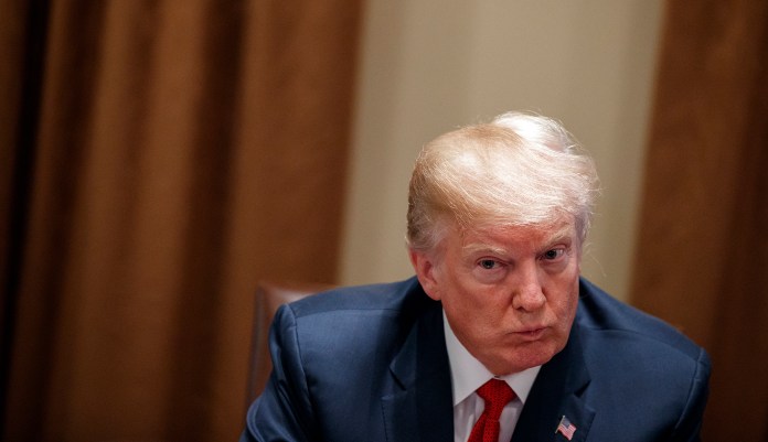 In this Feb. 6, 2018, photo, President Donald Trump listens during a meeting with law enforcement officials on the MS-13 street gang and border security, in the Cabinet Room of the White House in Washington. Trump is continuing his habit of painting immigrants as criminals, highlighting gang connections, calling family reunification a national security threat and bemoaning the death of a pro football player involved in a car accident with a man living in the country illegally.