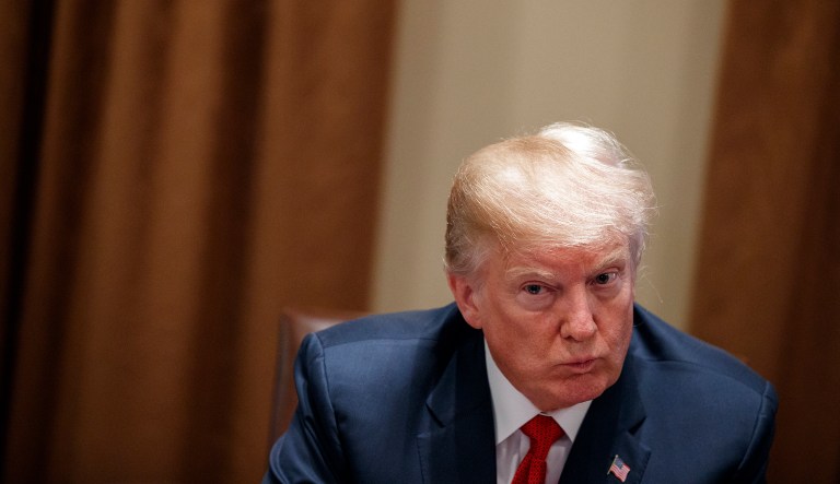 In this Feb. 6, 2018, photo, President Donald Trump listens during a meeting with law enforcement officials on the MS-13 street gang and border security, in the Cabinet Room of the White House in Washington. Trump is continuing his habit of painting immigrants as criminals, highlighting gang connections, calling family reunification a national security threat and bemoaning the death of a pro football player involved in a car accident with a man living in the country illegally.