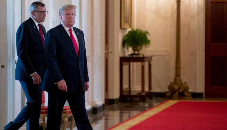 President Donald Trump, right, accompanied by Wounded Warrior Project CEO Michael Linnington, second from left, and Jose Ramos, left, arrives for a Wounded Warrior Project Soldier Ride event in the East Room of the White House, Thursday, April 18, 2019, in Washington.