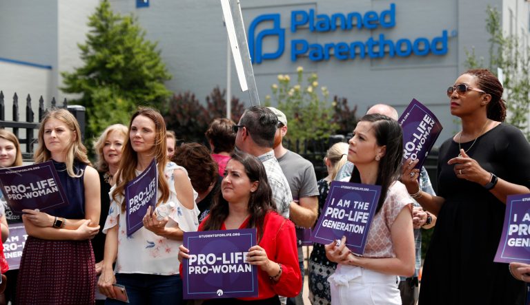 Anti-abortion advocates gather outside the Planned Parenthood clinic.