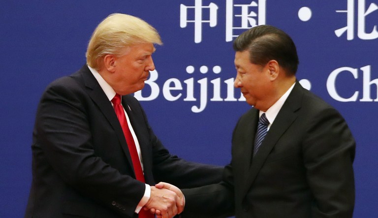 U.S. President Donald Trump, left, and Chinese President Xi Jinping shake hands during a business event at the Great Hall of the People in Beijing, Thursday, Nov. 9, 2017.