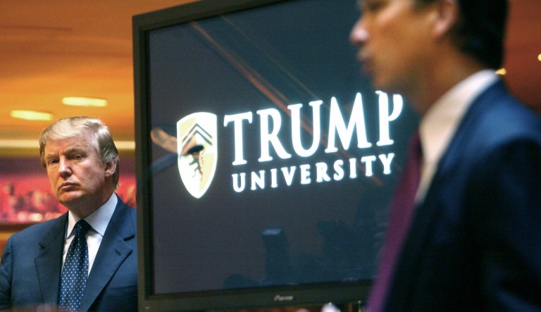 FILE- In this May 23, 2005 file photo, real estate mogul and Reality TV star Donald Trump, left, listens as Michael Sexton introduces him at a news conference in New York where he announced the establishment of Trump University. One day after Trump accepted the Republican nomination for president of the United States, his lawyers will be in court to try to get a lawsuit dismissed alleging that the business mogul defrauded customers who took courses with false promises of teaching success in real estate at the now-defunct Trump University. Lawyers for Trump will appear Friday, July 22, 2016, before U.S. District Judge Gonzalo Curiel to argue that a lawsuit against the nominee lacks merit.