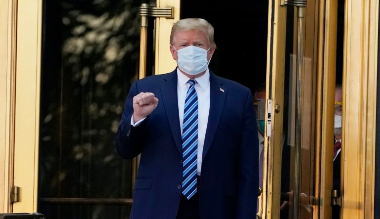 President Donald Trump walks out of Walter Reed National Military Medical Center to return to the White House after receiving treatments for covid-19, Monday, Oct. 5, 2020, in Bethesda, Md. 