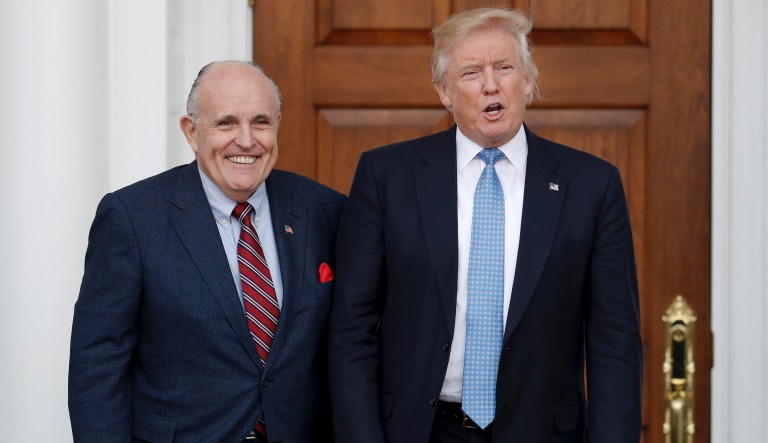 President-elect Donald Trump, right, and former New York Mayor Rudy Giuliani pose for photographs as Giuliani arrives at the Trump National Golf Club Bedminster clubhouse, Sunday, Nov. 20, 2016, in Bedminster, N.J.