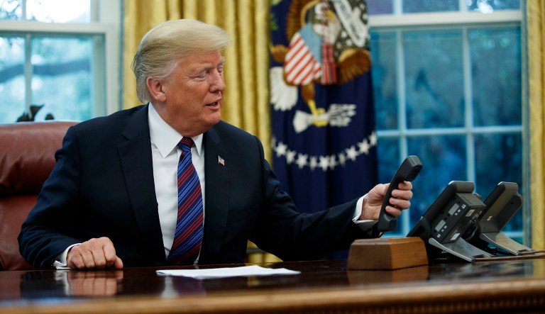 President Trump hangs up after talking with Mexican President Enrique Pena Nieto on the phone in the Oval Office of the White House, Monday, Aug. 27, 2018, in D.C.