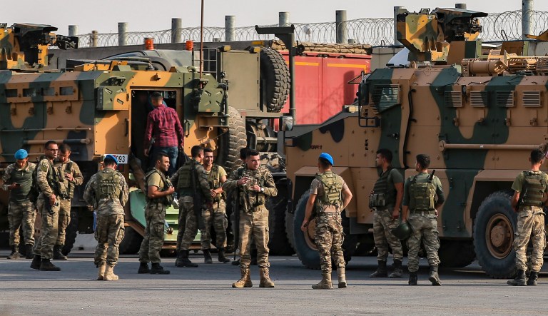 Turkish soldiers prepare to enter Syria aboard an armoured personnel carrier at the border with Syria in Karkamis, Gaziantep province, southeastern Turkey, Tuesday, Oct. 15, 2019. 