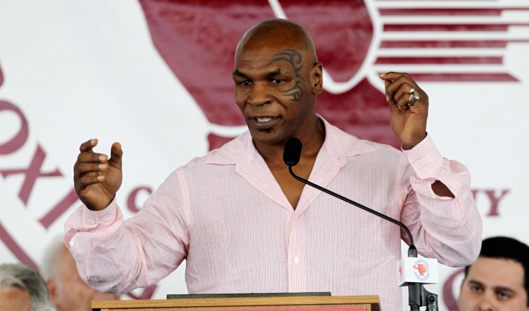 FILE - This June 12, 2011 file photo shows former boxer Mike Tyson at the Boxing Hall of Fame in Canastota, N.Y.  Tyson announced Monday, June 18, 2012 that he will team up with director Spike Lee to bring his one-man show "Mike Tyson: Undisputed Truth"  to the Longacre Theatre in New York for six nights only, from July 31 to Aug. 5.  The show, a raw confessional on the highs and lows of the life of the retired heavyweight and tabloid target, made its debut in April at the MGM Grand in Las Vegas. It will mark Lee's debut as a Broadway director.