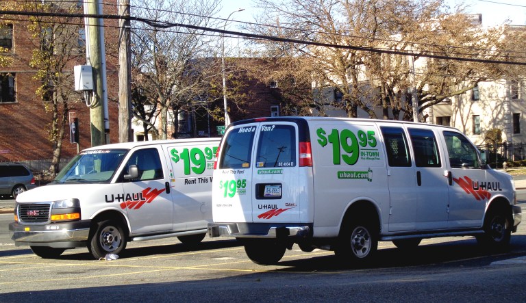 U-Haul vans sit in a parking lot in New York City.