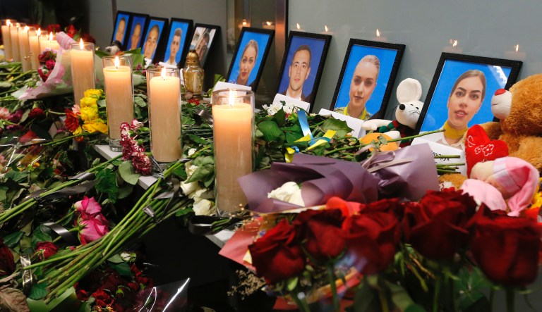 Flowers and candles are placed in front of portraits of the flight crew members of the Ukrainian 737-800 plane that crashed on the outskirts of Tehran, at a memorial inside Borispil international airport outside Kyiv, Ukraine, Saturday, Jan. 11, 2020. Ukraine's President Volodymyr Zelenskiy says that Iran must take further steps following its admission that one of its missiles shot down Ukrainian civilian airliner. He also expressed hope for the continuation of the crash investigation without delay. A team of Ukrainian investigators is in Iran.
