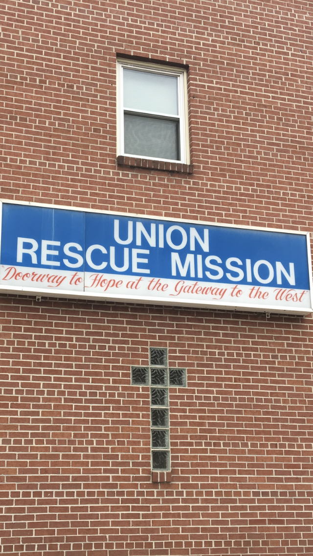 The sign for the Union Rescue Mission outside the shelter and dining room is seen along Queen City Pavement, a street that parallels the railroad tracks in Cumberland, Maryland.