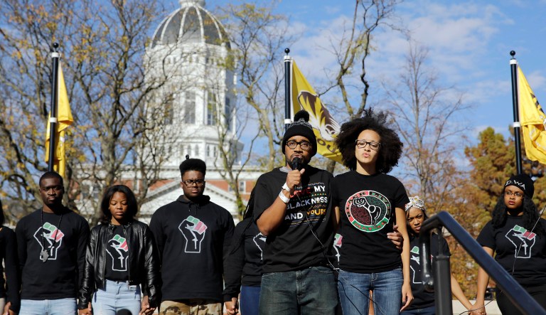 FILE - In this Nov. 9, 2015, file photo, Jonathan Butler, center, addresses a crowd in Columbia following the resignation of University of Missouri System President Tim Wolfe after days of protests over concerns about the administrationâs handling of racial issues. With changes afoot, the University of Missouri is facing a challenge: How to repair the schoolâs image nationally and statewide.