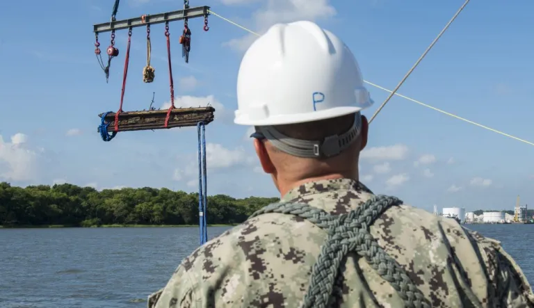 Chief Warrant Officer 3, Jason Potts supervises as a piece of casemate is raised from the Savannah River.