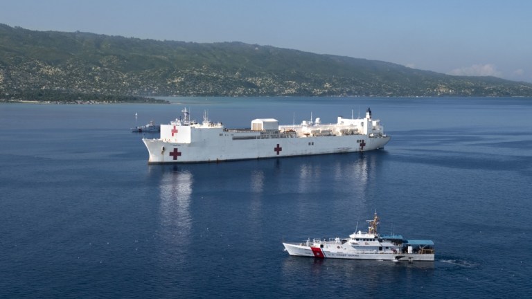 USCGC Margaret Norvell (WPC 1105), front, and USCGC Kathleen Moore (WPC 1109) sail alongside the hospital ship USNS Comfort (T-AH 20) as it is anchored off the coast of Port-Au-Prince, Haiti in preparation for a six-day medical mission, Nov. 4, 2019.