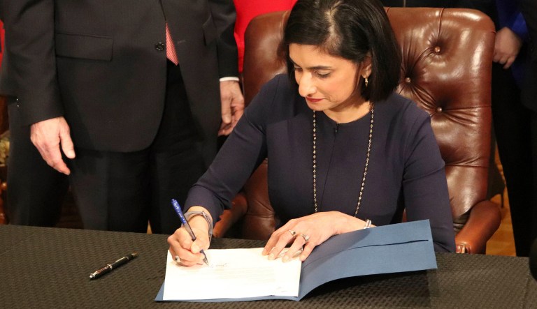 Seema Verma, the head of the Centers for Medicare and Medicaid Services, signs paperwork at the state Capitol in Little Rock, Ark., on Monday, March 5, 2018. 