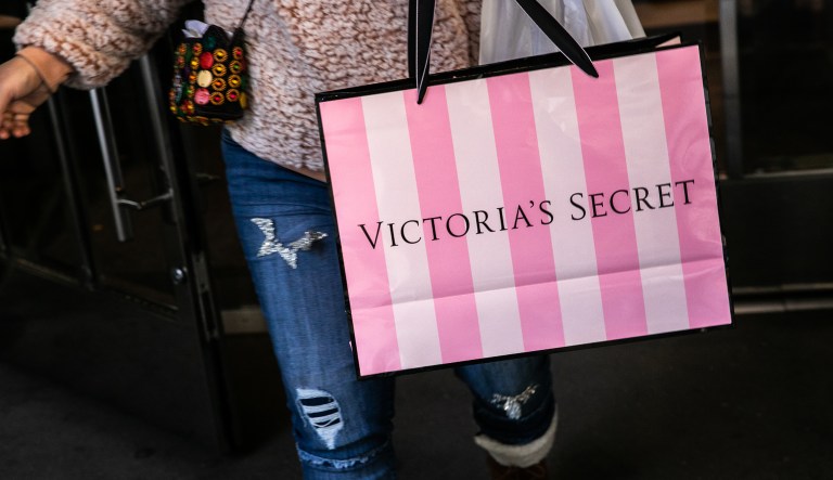 A customer carries a shopping bag while exiting a Victoria's Secret Stores LLC store, a subsidiary of L Brands Inc., in New York, U.S., on Wednesday, Nov. 14, 2018.