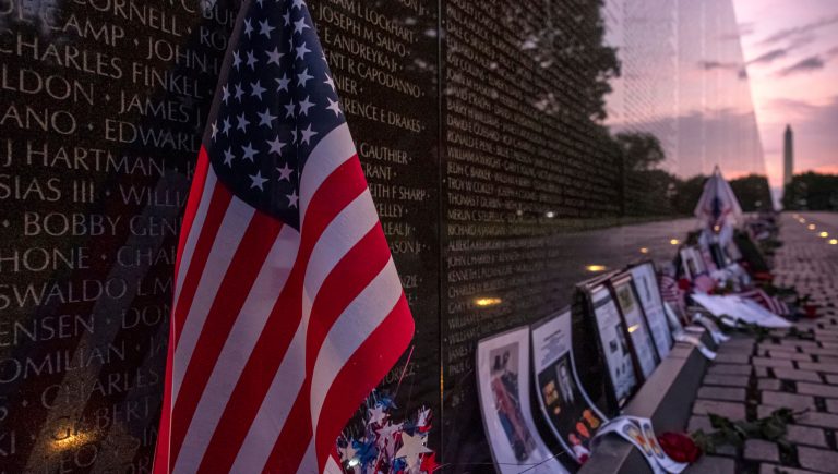 A U.S. Flag rests against the Memorial Wall of the Vietnam Veterans Memorial in Washington.