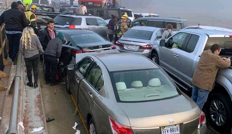 Drivers and emergency personnel remain on the scene of a multi-vehicle pileup on Interstate 64 in York County, Va., Sunday, Dec. 22, 2019.