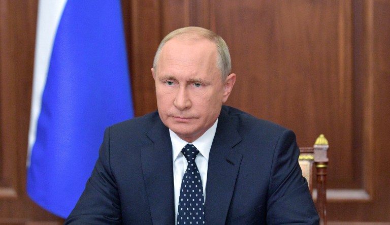 Russian President Vladimir Putin makes an address on the state TV in the Kremlin in Moscow, Russia, Wednesday, Aug. 29, 2018. Putin in a televised address Wednesday said without raising the retirement age Russia's pension system "would crack and eventually collapse." He offered concessions to the reform, saying that women's retirement age should increase from 55 to 60 years, lower than had proposed.