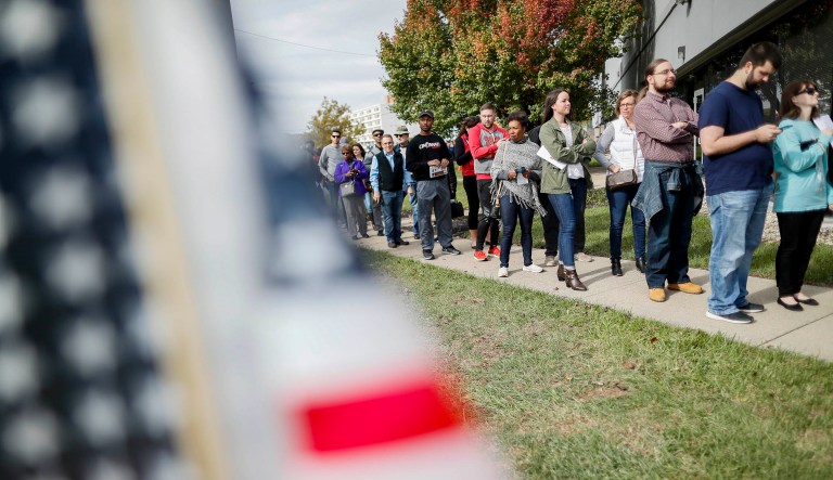 A line forms for early voting at the Hamilton County Board of Elections, Sunday, Nov. 4, 2018, in Cincinnati. 