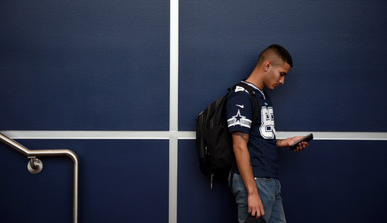 A man looks at his mobile phone during early voting at a polling location in San Antonio, Texas, on Monday, Oct. 22, 2018.