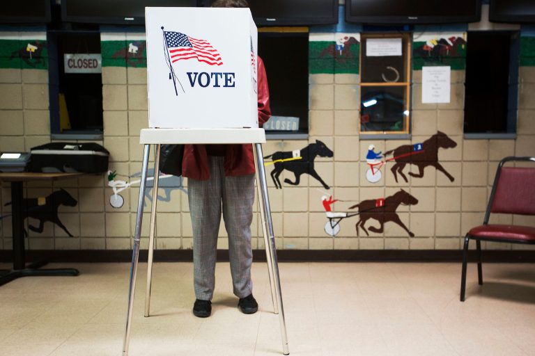 Voters line up to cast their ballots for early voting at the Johnson County Arts & Heritage Center on Friday in Overland Park, Kan. Poll workers said turnout this election is way above average with about 22,000 early votes cast so far at this location. 