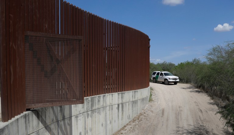 FILE - In this Aug. 11, 2017, file photo, a U.S. Customs and Border Patrol vehicle passes along a section of border levee wall in Hidalgo, Texas. The Department of Homeland Security has issued another waiver of environmental laws to build new border barriers in South Texas, this time for roughly 17 miles (27 kilometers) of new border wall. DHS posted a waiver Wednesday, Oct. 10, 2018, that lists six sections where it plans to build "physical barriers and roads" in the Rio Grande Valley, at the southernmost point of Texas.