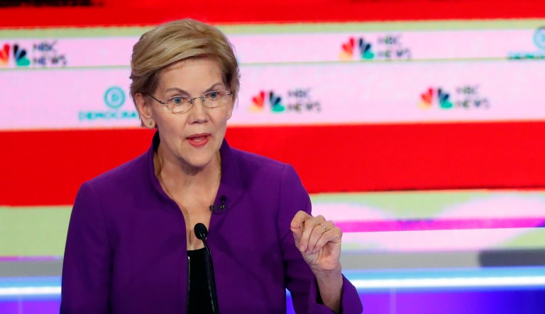 Democratic presidential candidate Sen. Elizabeth Warren, D-Mass., answers a question, as former Texas Rep. Beto O'Rourke listens during a Democratic primary debate hosted by NBC News at the Adrienne Arsht Center for the Performing Art, Wednesday, June 26, 2019, in Miami.
