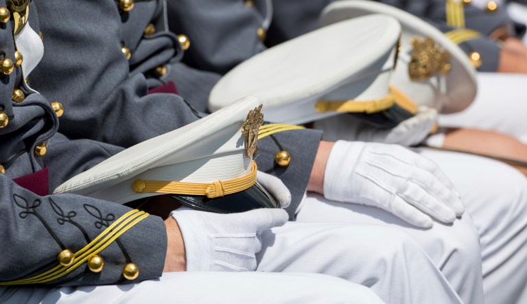 West Point cadets hold their caps on their laps during graduation ceremonies at the United States Military Academy, Saturday, May 25, 2019, in West Point, N.Y.