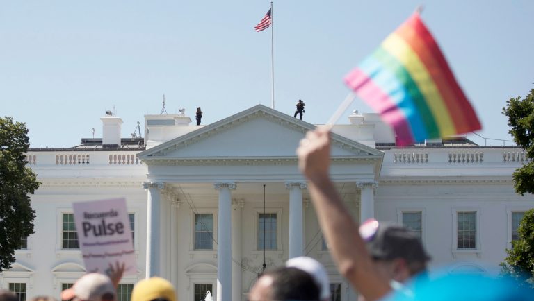 FILE - In this Sunday, June 11, 2017 file photo, Equality March for Unity and Pride participants march past the White House in Washington. Many LGBT-rights activists never believed Donald Trump's campaign promises to be their friend. With his move to ban transgender people from military service on Wednesday, July 26, 2017, on top of other actions and appointments, they now see him as openly hostile. 