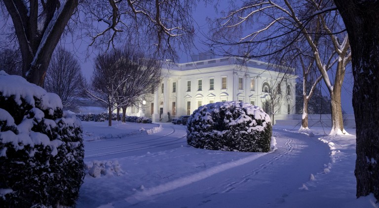 The White House is seen as snow continues to fall, Sunday, Jan. 13, 2019, in Washington.