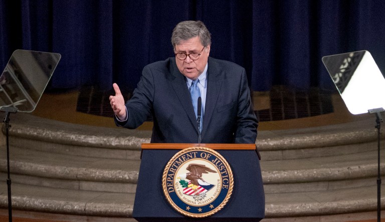 Attorney General William Barr, center, accompanied by Deputy Attorney General Jeffrey Rosen, right, speaks at the Justice Department's National Opioid Summit at the Department of Justice, Friday, March 6, 2020, in Washington.