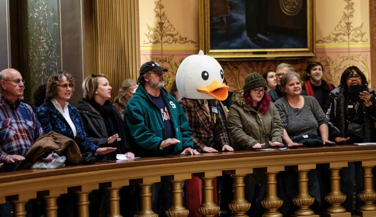 In this Tuesday, Dec. 4, 2018, photo, people gather to protest at the Capitol Rotunda in Lansing, Mich. The incoming Democratic governor of Wisconsin said Wednesday that he plans to make a personal appeal to his defeated rival, Gov. Scott Walker, to veto far-reaching GOP legislation that would restrict the new administration's powers.