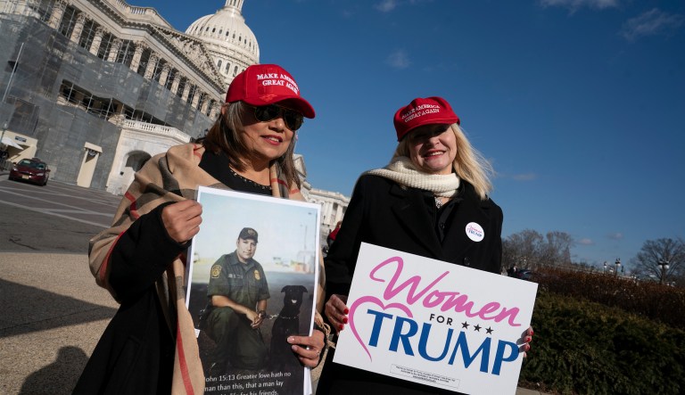 Marie Herrera Vega of La Feria, Texas, left, and Mary Noldy of Scranton, Pa., wait to join other women Trump supporters and family members of Americans killed by undocumented immigrants to promote their support for a border wall with Mexico, at the Capitol in Washington, Wednesday, Feb. 13, 2019.