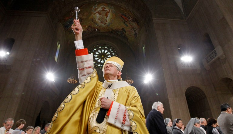 In this Sunday, April 24, 2011 file photo, Cardinal Donald Wuerl, Archbishop of Washington, sprinkles Holy Water during Easter Mass at the Basilica of the National Shrine of the Immaculate Conception Roman Catholic Church in Washington. On Tuesday, Aug. 14, 2018, a Pennsylvania grand jury accused Cardinal Wuerl of helping to protect abusive priests when he was Pittsburgh's bishop.