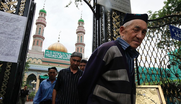 Uighur men come out from a mosque after praying at Uighur sector in Urumqi, western China's Xinjiang province, Tuesday, July 14, 2009. 