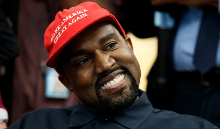 Musician Kanye West smiles as he listens to a question from a reporter during a meeting in the Oval Office of the White House with President Donald Trump, Thursday, Oct. 11, 2018, in Washington.
