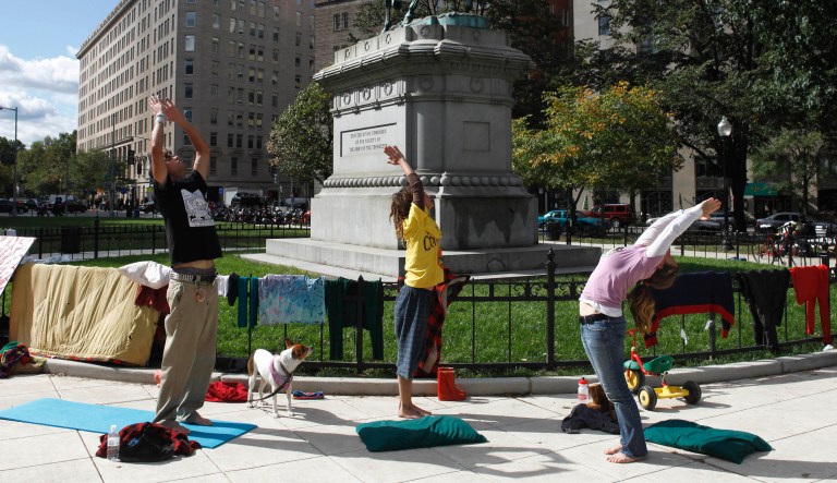 Occupy DC protesters do yoga in McPherson Square in Washington, Thursday, Oct. 20, 2011.