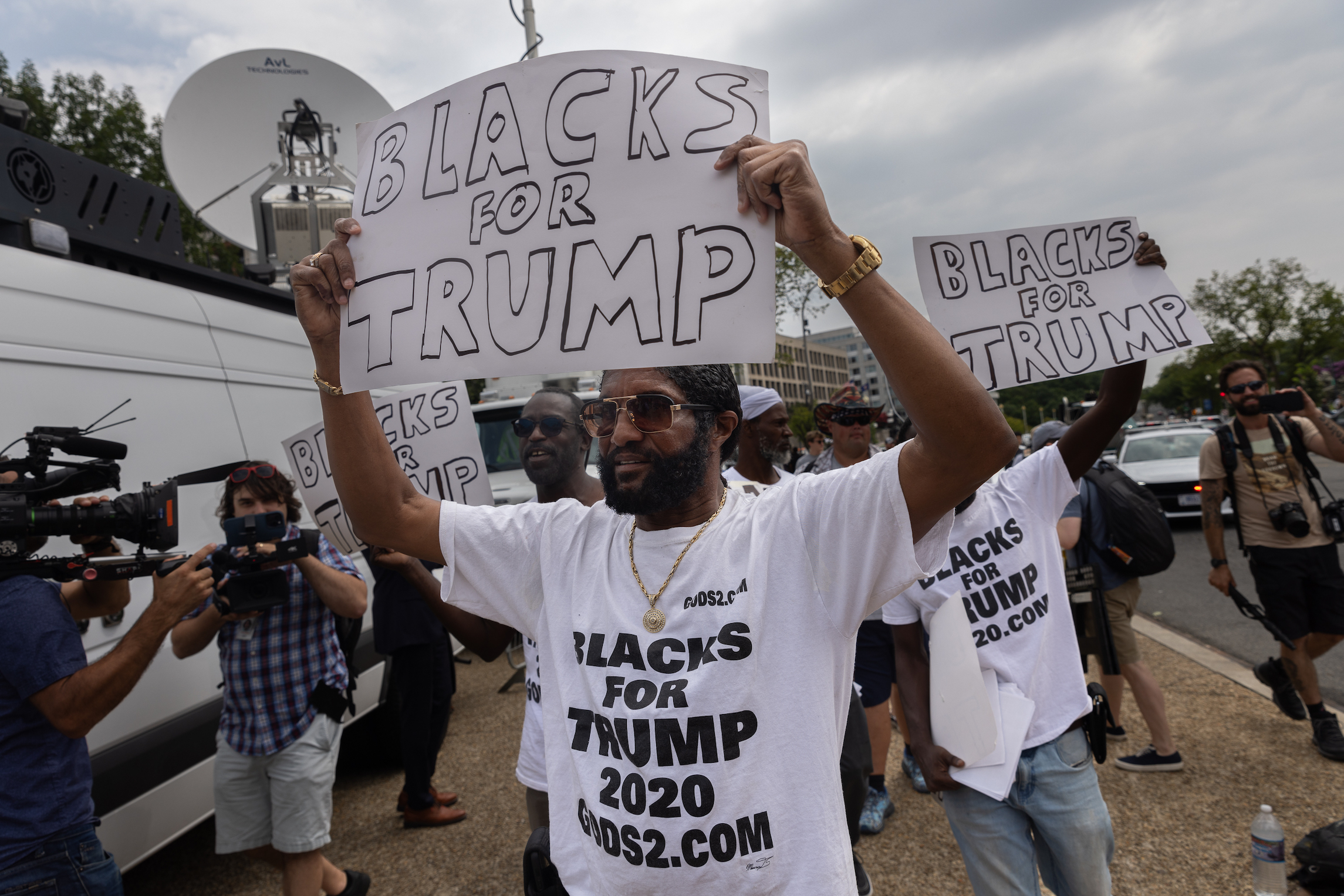 Men hold “Blacks for Trump” signs outside the U.S. District Court, on Thursday August 3, 2023. Former President Donald Trump was arraigned on four criminal counts related to his involvement with the January 6 Insurrection, and alleged efforts to overturn the 2020 presidential elections.