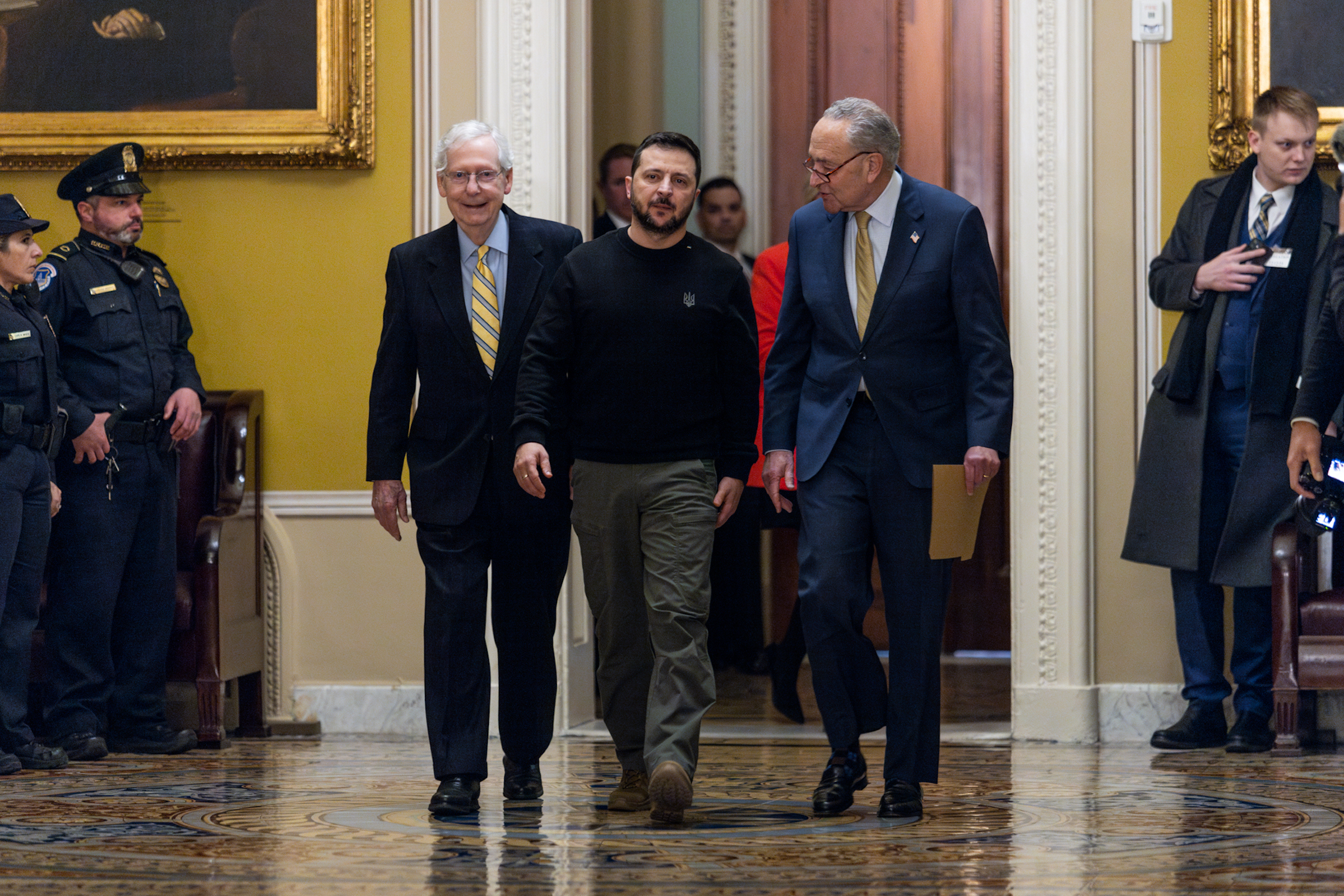 Ukrainian President Volodymyr Zelensky walks with Senate Minority Leader Mitch McConnell (R-KY) and Senate Majority Leader Charles Schumer (D-NY) as he arrives at the U.S. Capitol to meet with Congressional leadership on Tuesday, December 12, 2023. Zelensky met with Congressional leaders and President Biden this week to discuss continuing military aid as the country runs out of money in their war against Russia. 