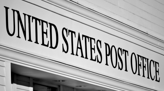 Updated: Postal service officials see no conflicts when its top real estate agent also represents buyers