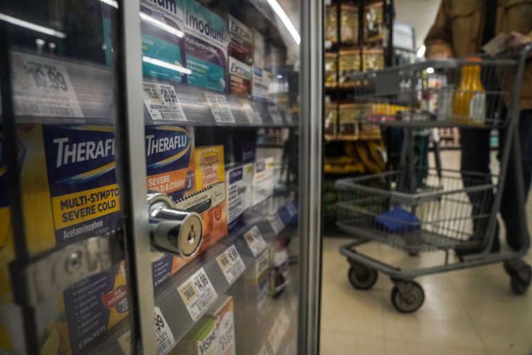 Pharmaceutical items are kept locked in a glass cabinet at a supermarket on Tuesday, Jan. 31, 2023.