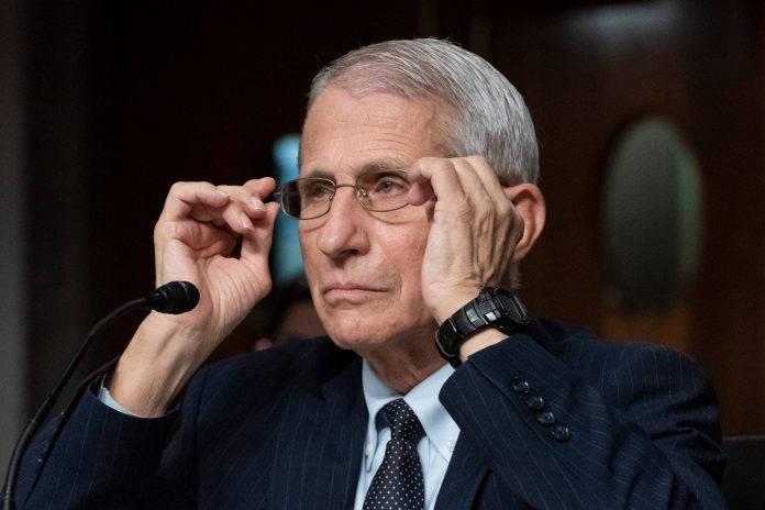 Dr. Anthony Fauci, director of the National Institute of Allergy and Infectious Diseases, adjusts his glasses during a Senate Health, Education, Labor, and Pensions Committee hearing on Capitol Hill, Nov. 4, 2021, in Washington. Fauci is expected to testify before Congress early next year as part of Republicansâ yearslong investigation into the origins of COVID-19 and the U.S. response to the disease. Fauci will sit for transcribed interviews in early January and a public hearing at a later date.